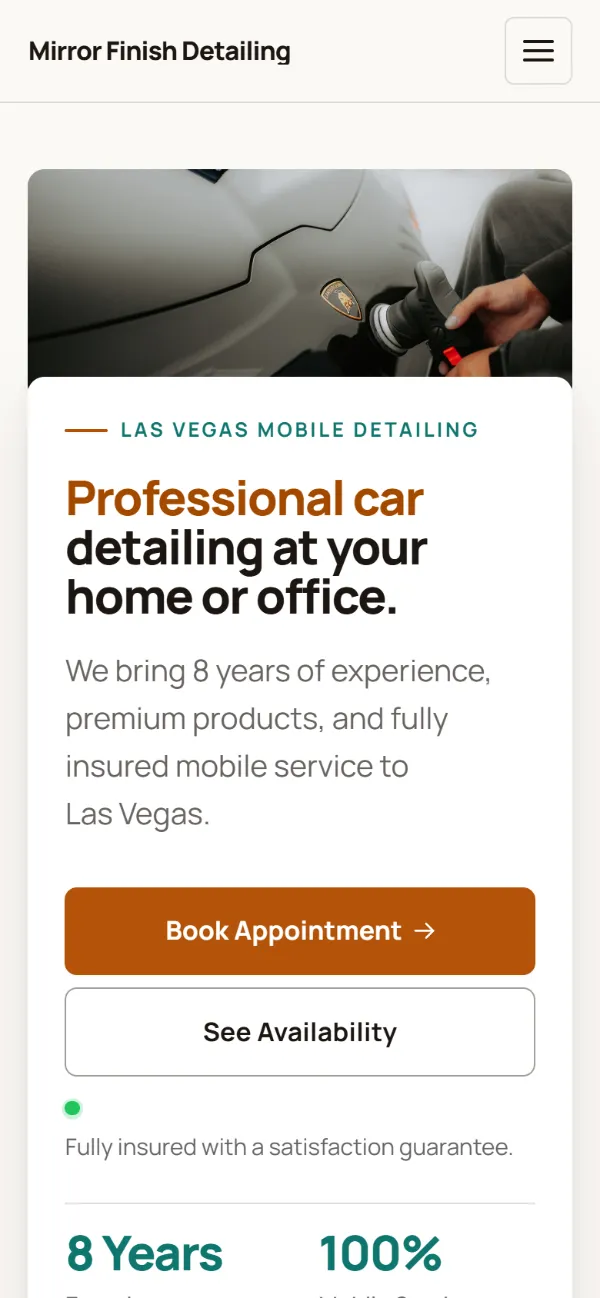 Warm car detailing website template on a phone: soft cards and warm colours under a wide photo