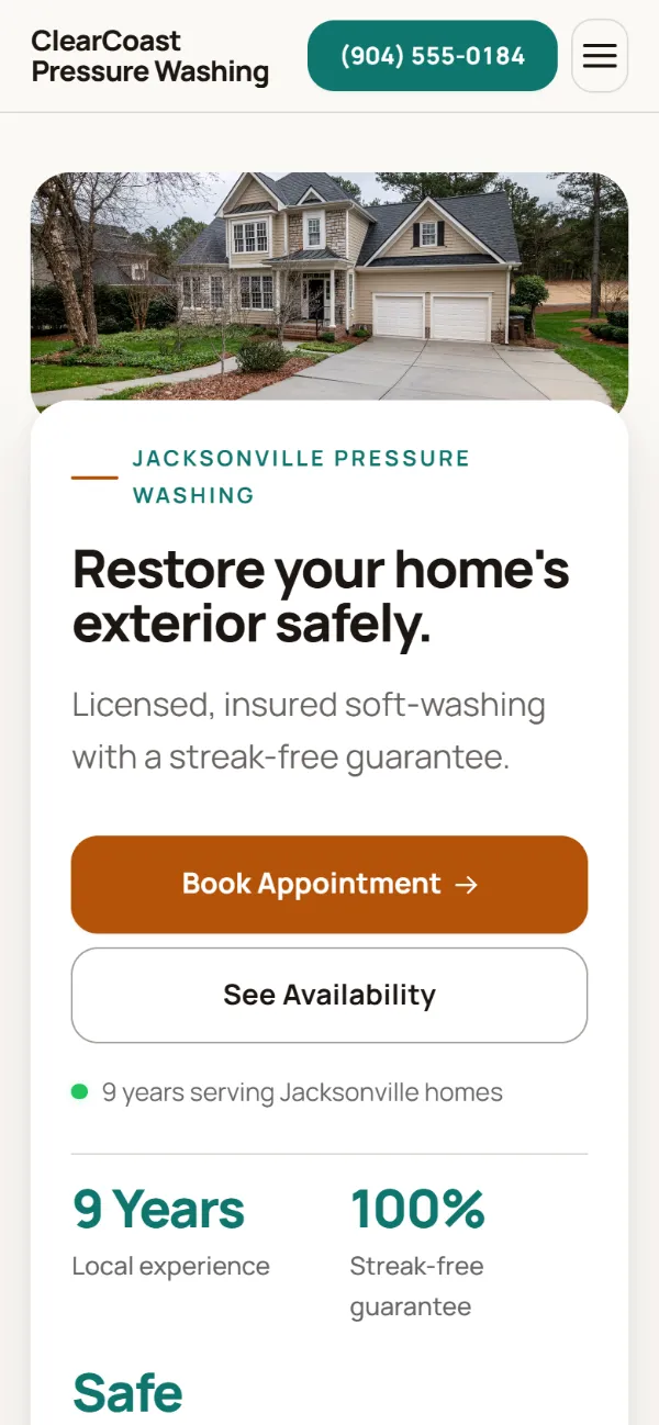 Warm pressure washing website template on a phone: soft cards and warm colours under a wide photo