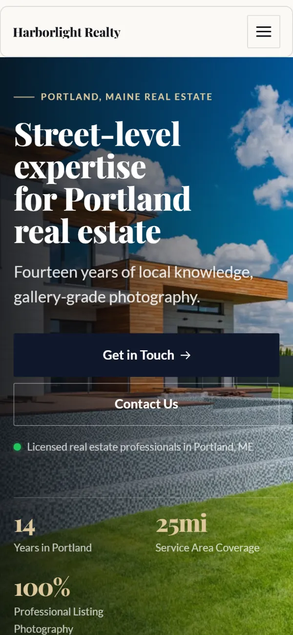 Luxury real estate website template on a phone: dark and understated, with a serif headline over a full-width photo